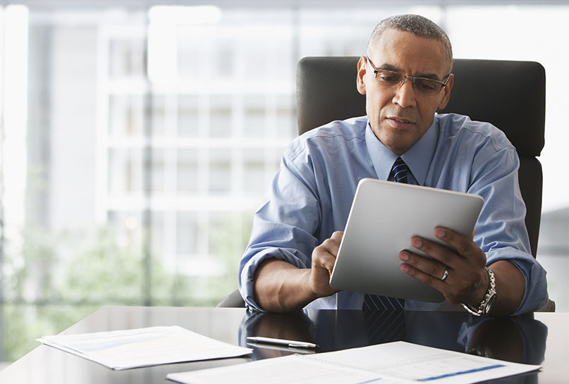 business-man-reviewing-at-desk.jpg